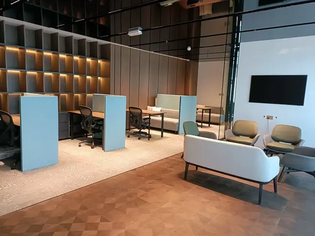 Prestige Group: Open office with lit timber shelving and soft seating